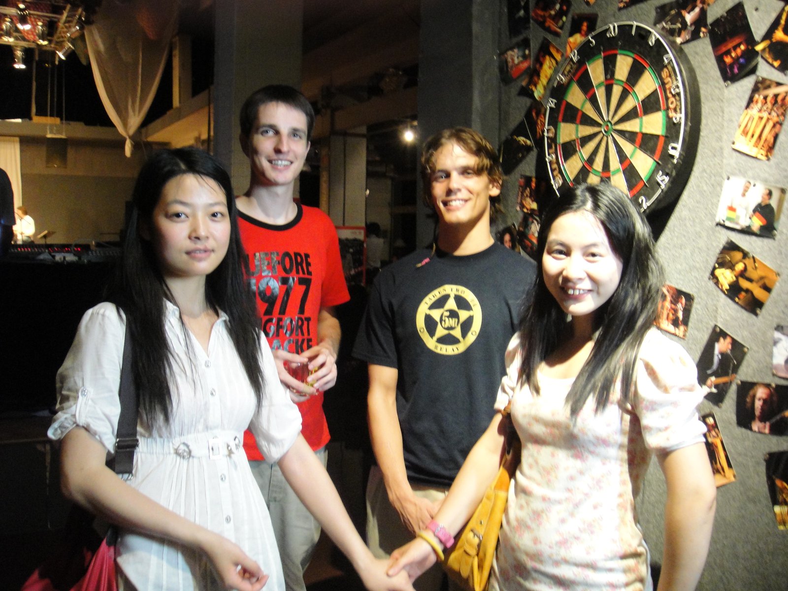 Me, Tim, Yoyo, and Nicole standing in front of the dartboard.