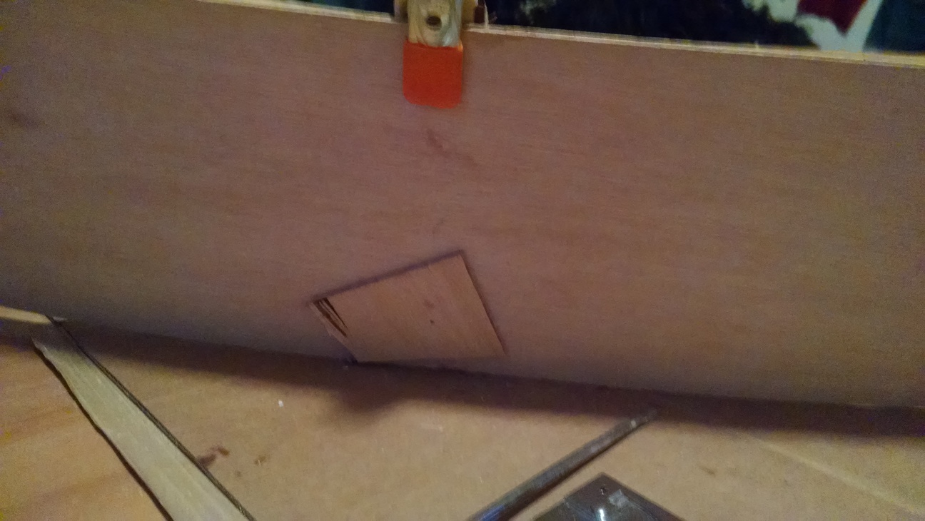 Closeup of how I temporarily nailed the frame into the hull until the epoxy cured.