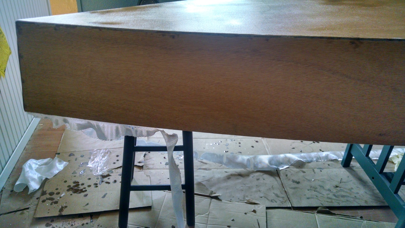 Hull upside down and covered with fiberglass sheet and epoxy.