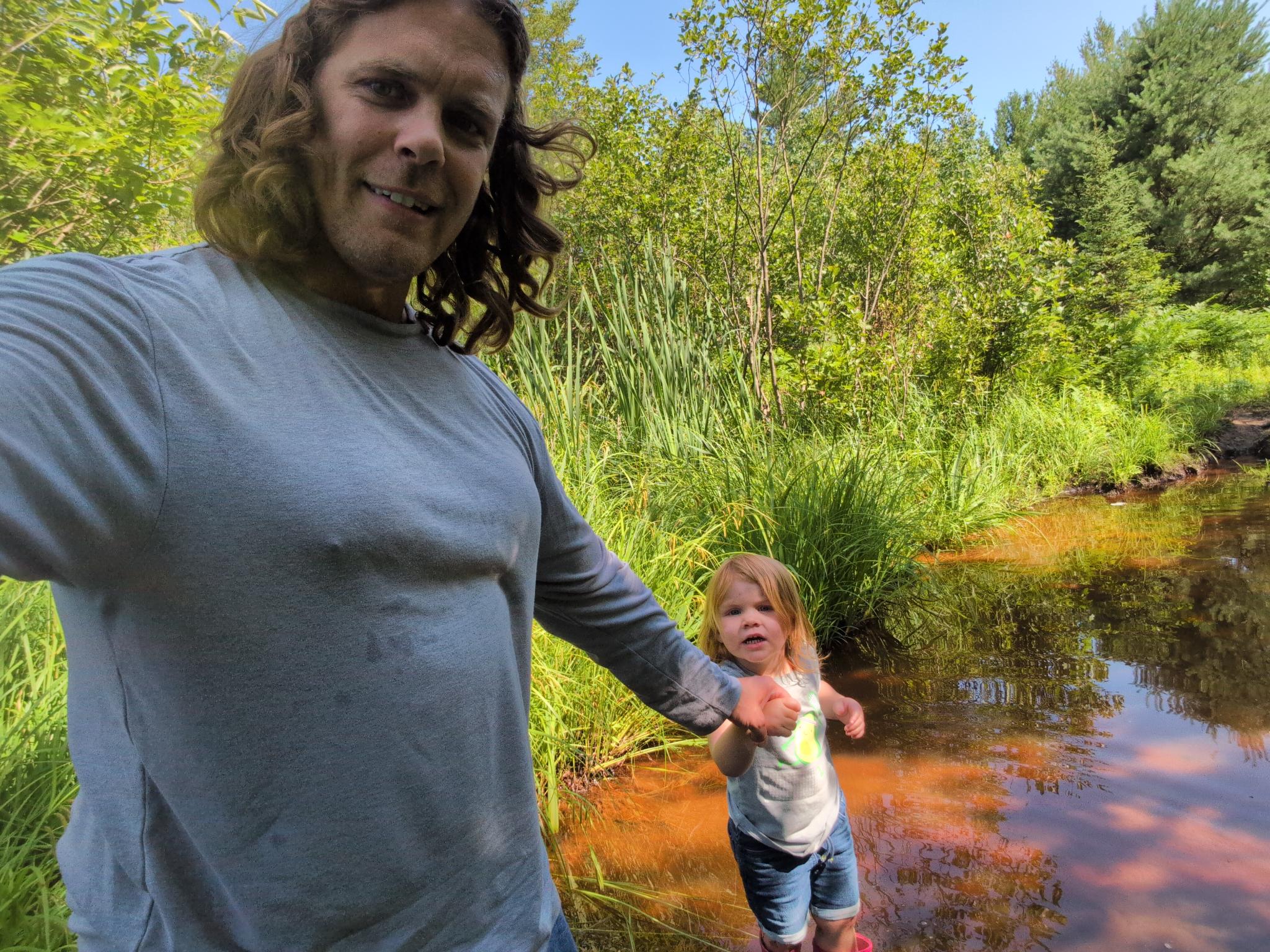Riley exploring flooded creek crossing.