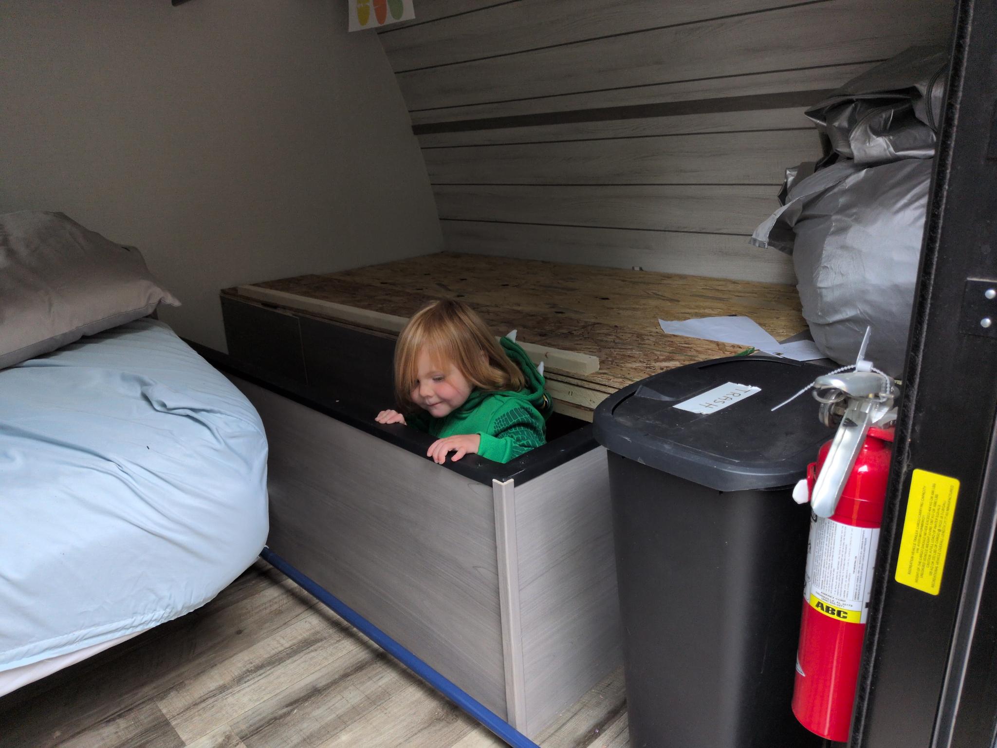 Riley climbing through under the bed.
