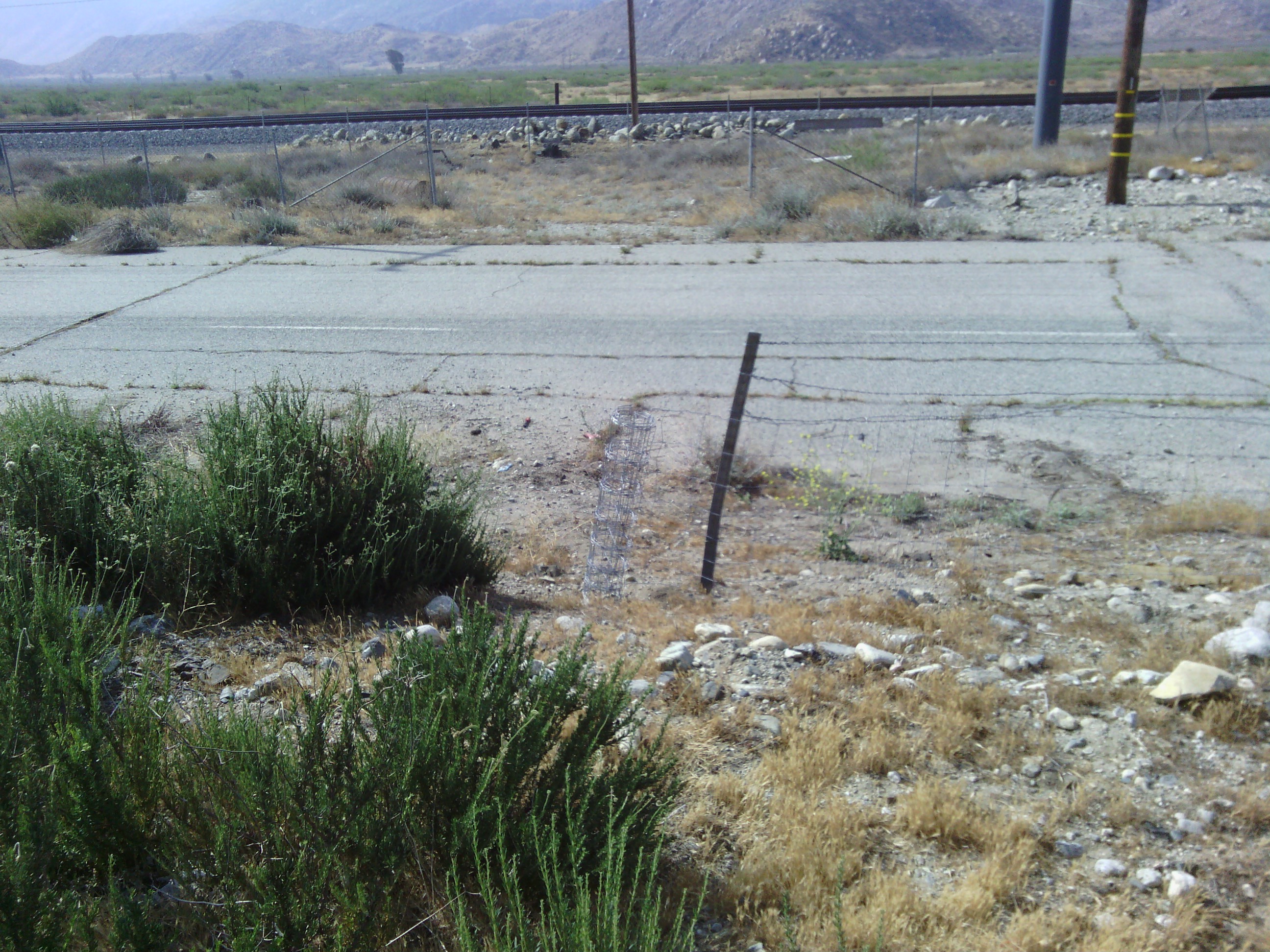 The cut fence to the frontage road