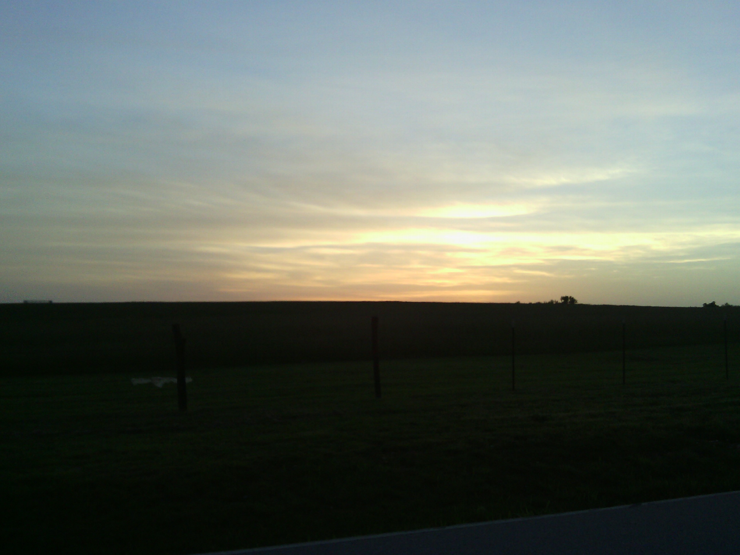 Sun setting over a Missouri field as I rode to the campground