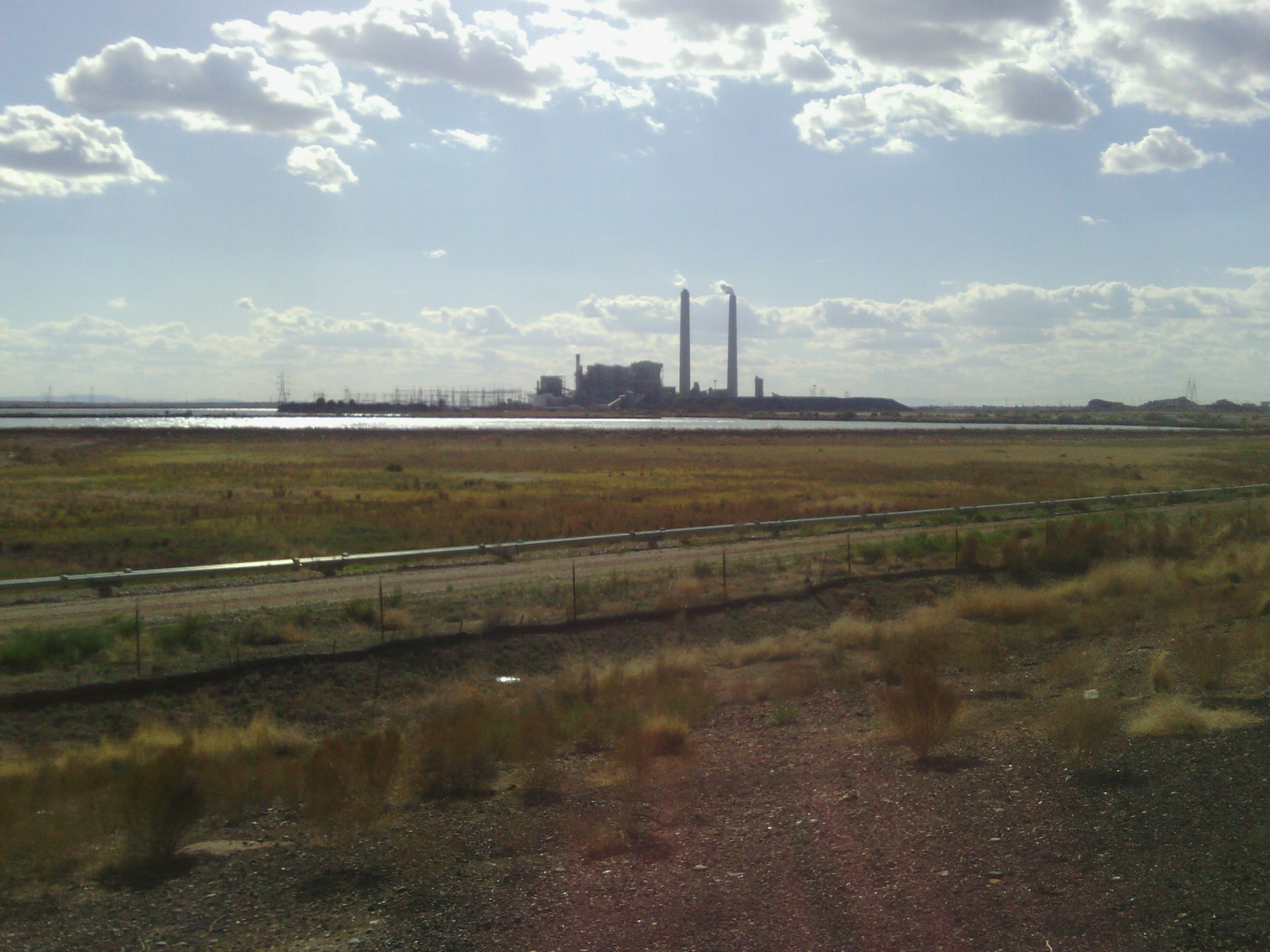 A factory outside Holbrook. It&rsquo;s pretty until you realize that smoke is probably toxic, and the reflecting pool might be a chromium holding pond