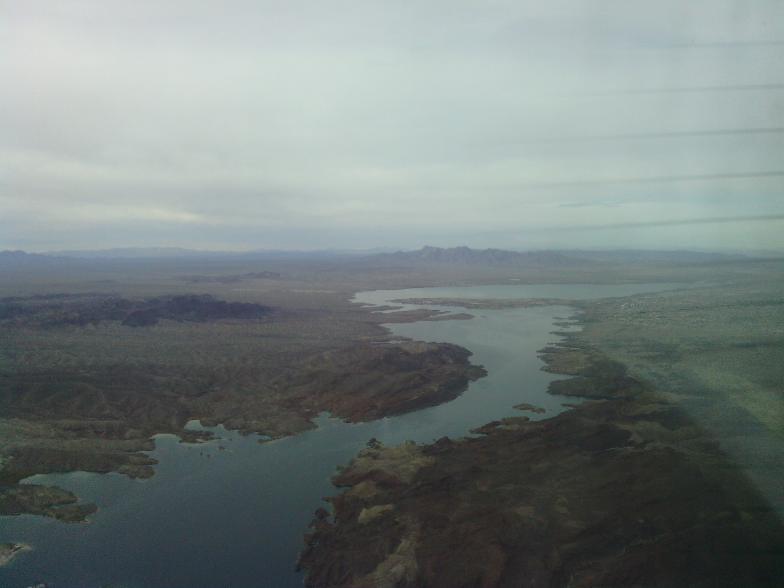 The Colorado and Lake Havasu from the air. The lines on the right are the propeller crossing the frame.