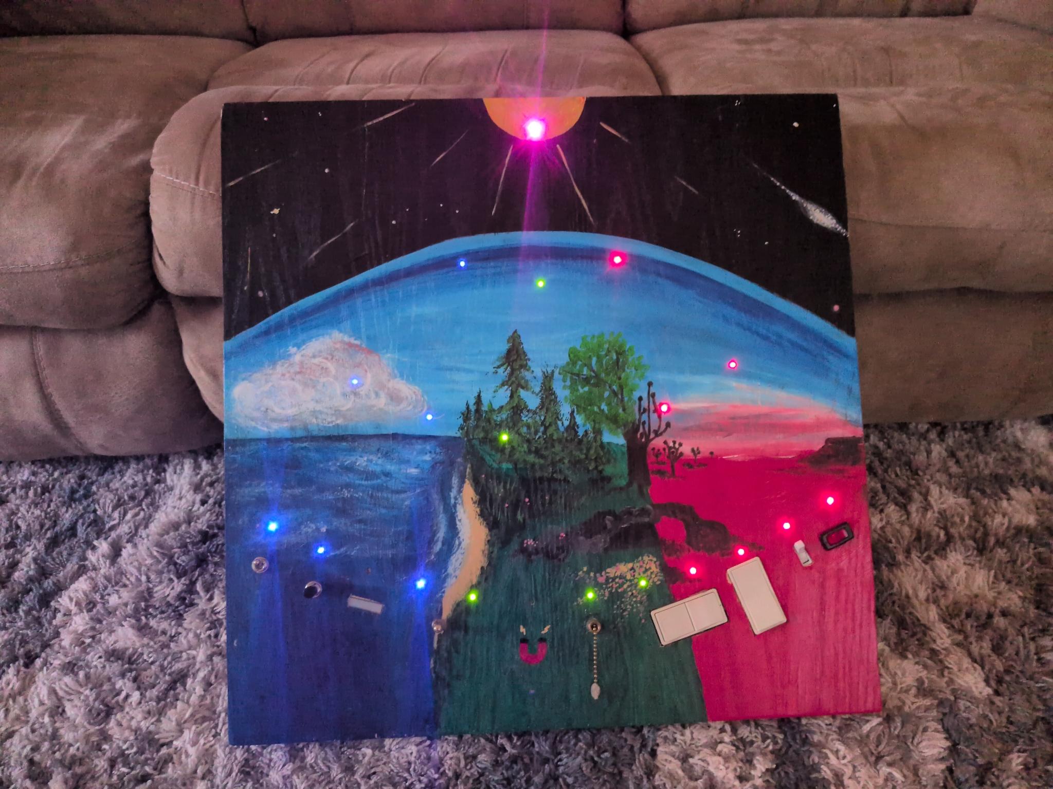 The finished light board showing the front art with some of the lights on and the sun burning full white