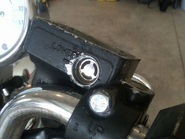 The bulk of the old lens has been removed, but there is still lots of residue along the trim ring