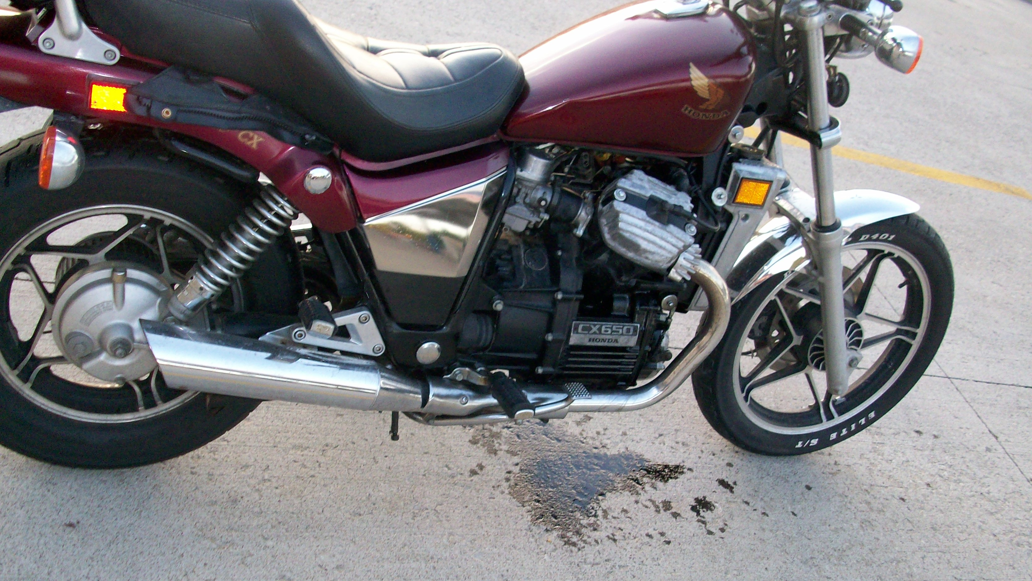 My motorcycle with its missing saddle bag and spilled oil
