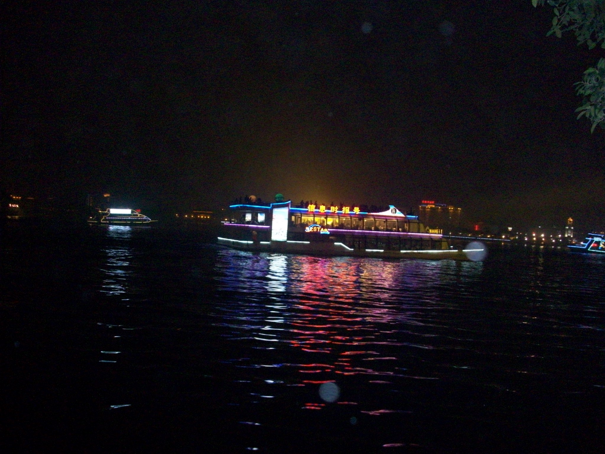 There is a pearl river dinner cruise with fancy boats.  They are very well-lit and they looked awesome against the city lights.